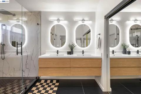 a bathroom with mirror and sink