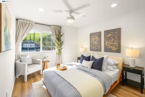 a bedroom with a bed and a large window