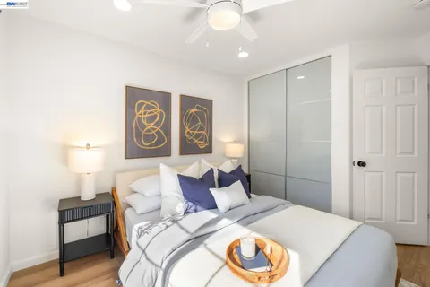 a bedroom with a bed and a lamp on table