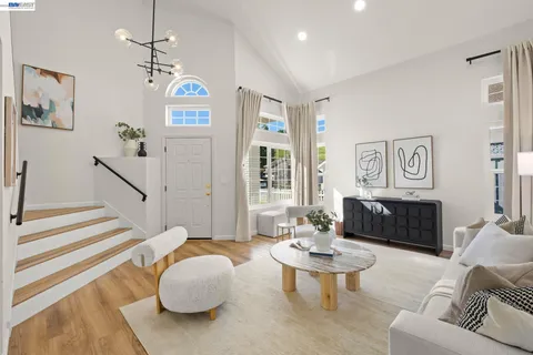 a living room with furniture potted plant and a chandelier
