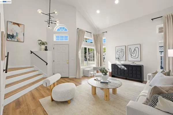 a living room with furniture potted plant and a chandelier