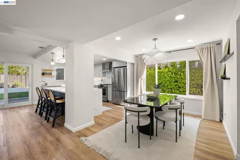 a dining room with furniture and wooden floor