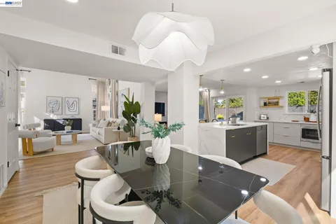a living room with kitchen island furniture and a view of kitchen