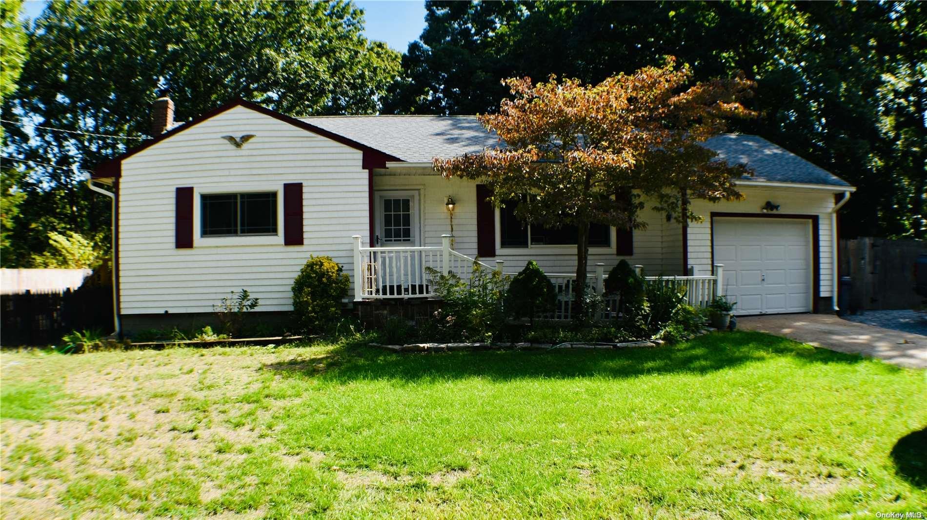 39 Forest Road Centereach, NY 11720 - Photo 1 of 1 a front view of a house with a yard