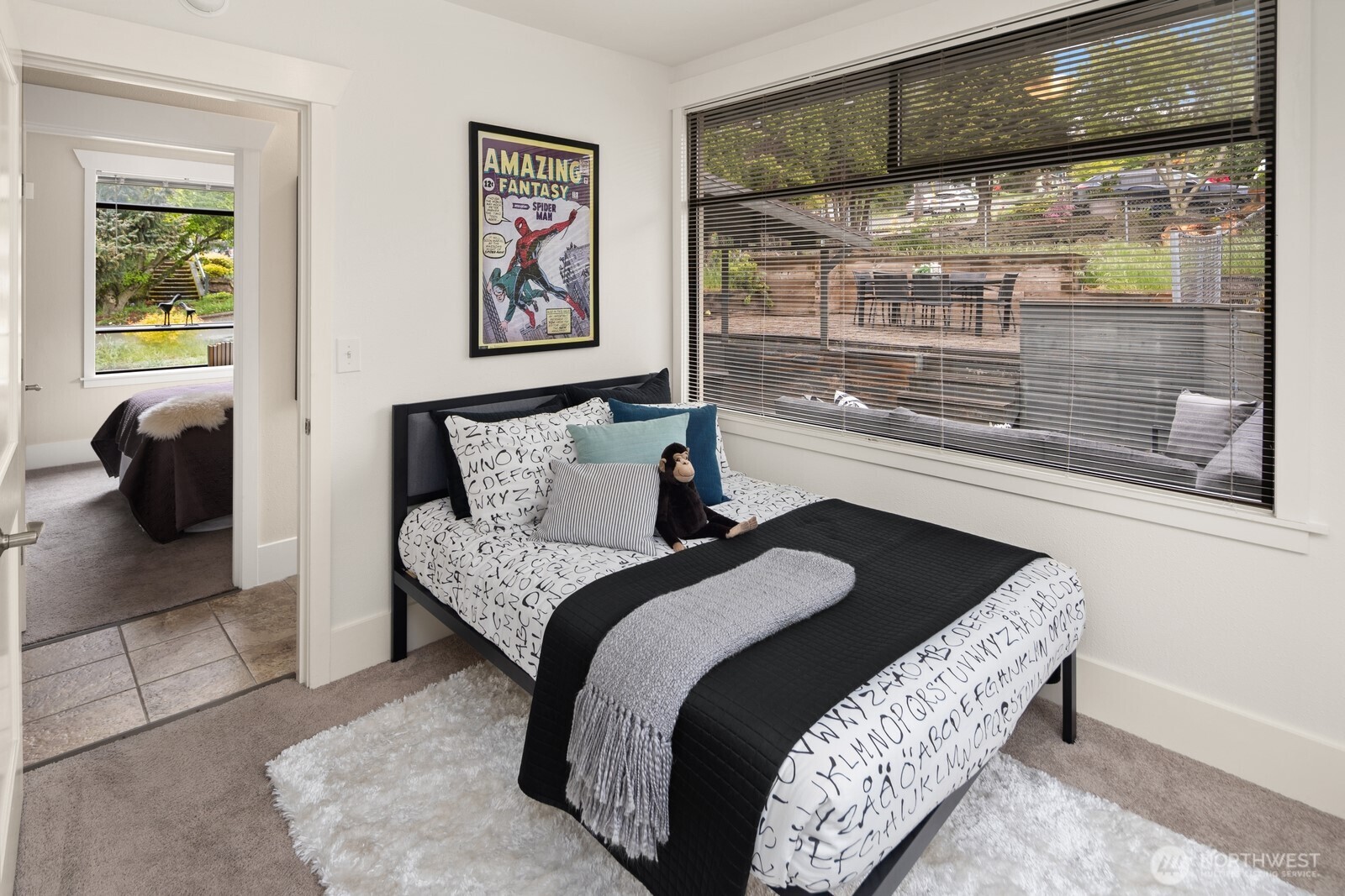 4522 3rd Avenue Northwest Seattle, WA 98107 - Photo 14 of 30 a bedroom with a bed and glass window