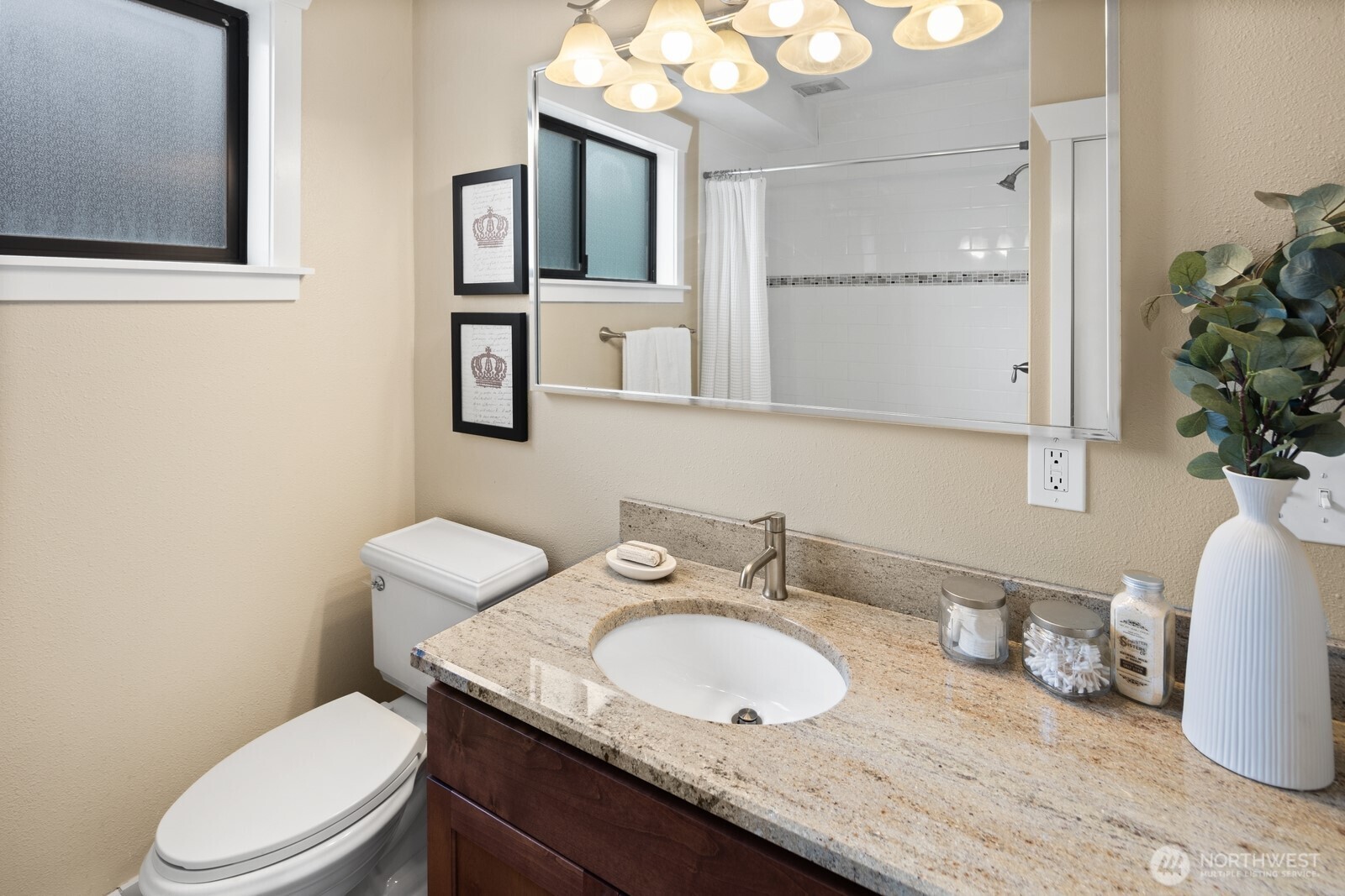 4522 3rd Avenue Northwest Seattle, WA 98107 - Photo 17 of 30 a bathroom with a granite countertop toilet sink and mirror