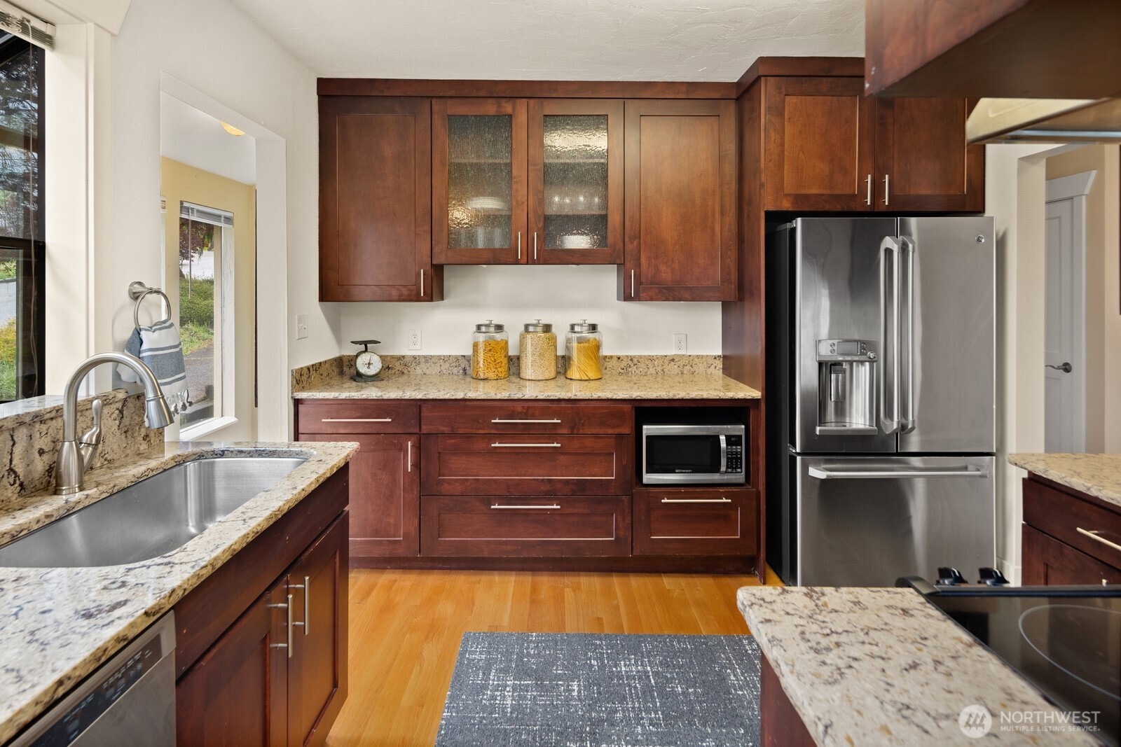 4522 3rd Avenue Northwest Seattle, WA 98107 - Photo 6 of 30 a kitchen with stainless steel appliances granite countertop a refrigerator and a sink