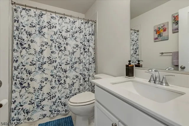 a bathroom with a sink toilet and a mirror