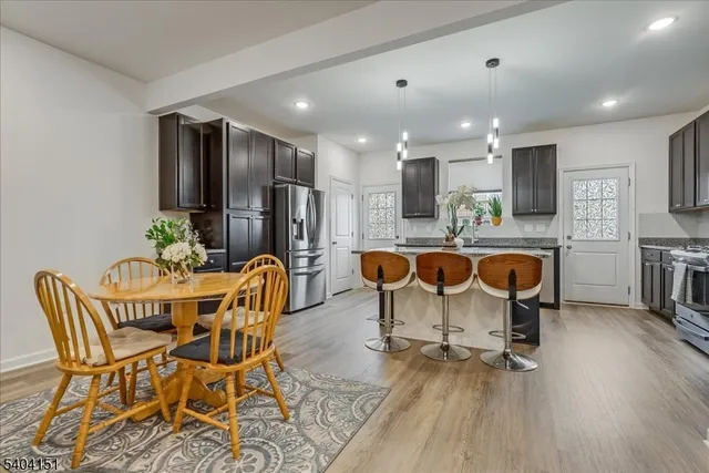a dining room with furniture and wooden floor