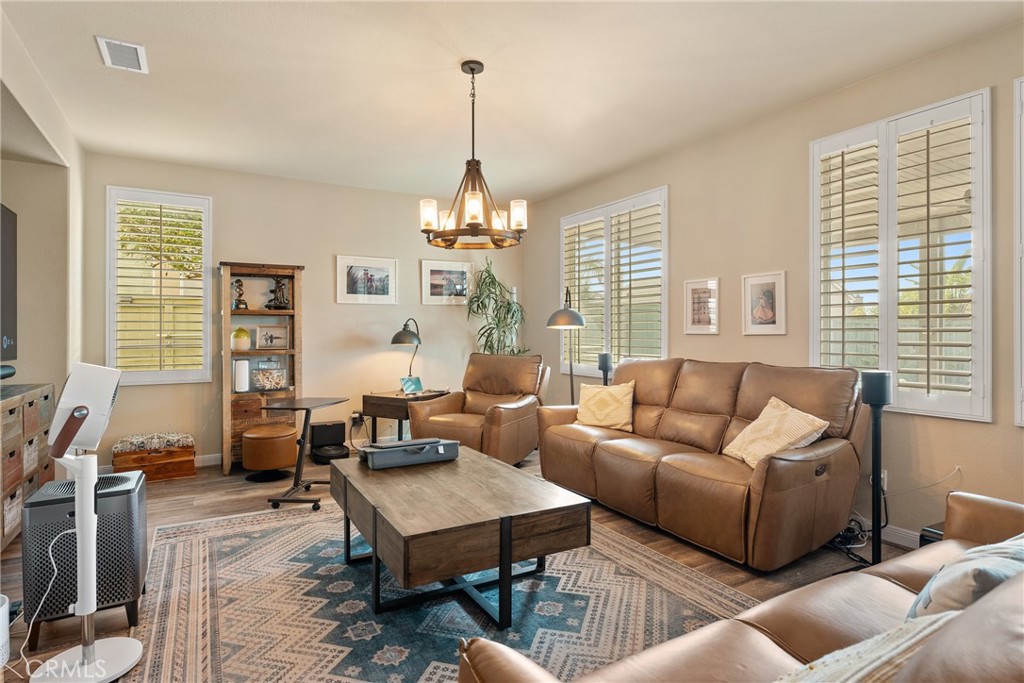 8553 Lodgepole Lane Riverside, CA 92508 - Photo 15 of 75 a living room with furniture a table and a large window