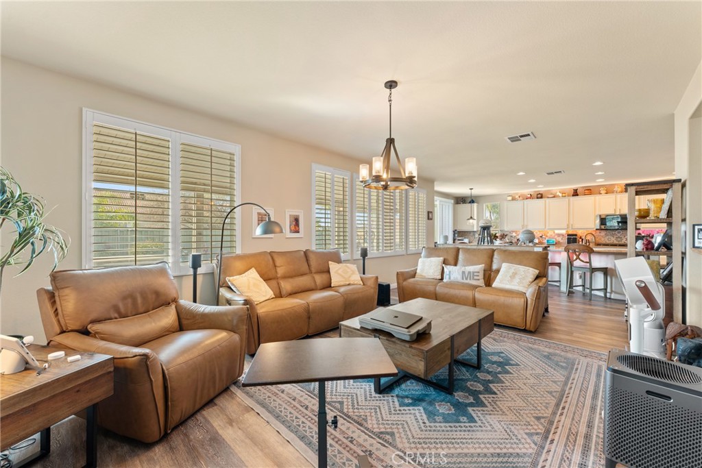8553 Lodgepole Lane Riverside, CA 92508 - Photo 16 of 75 a living room with furniture kitchen view and large windows