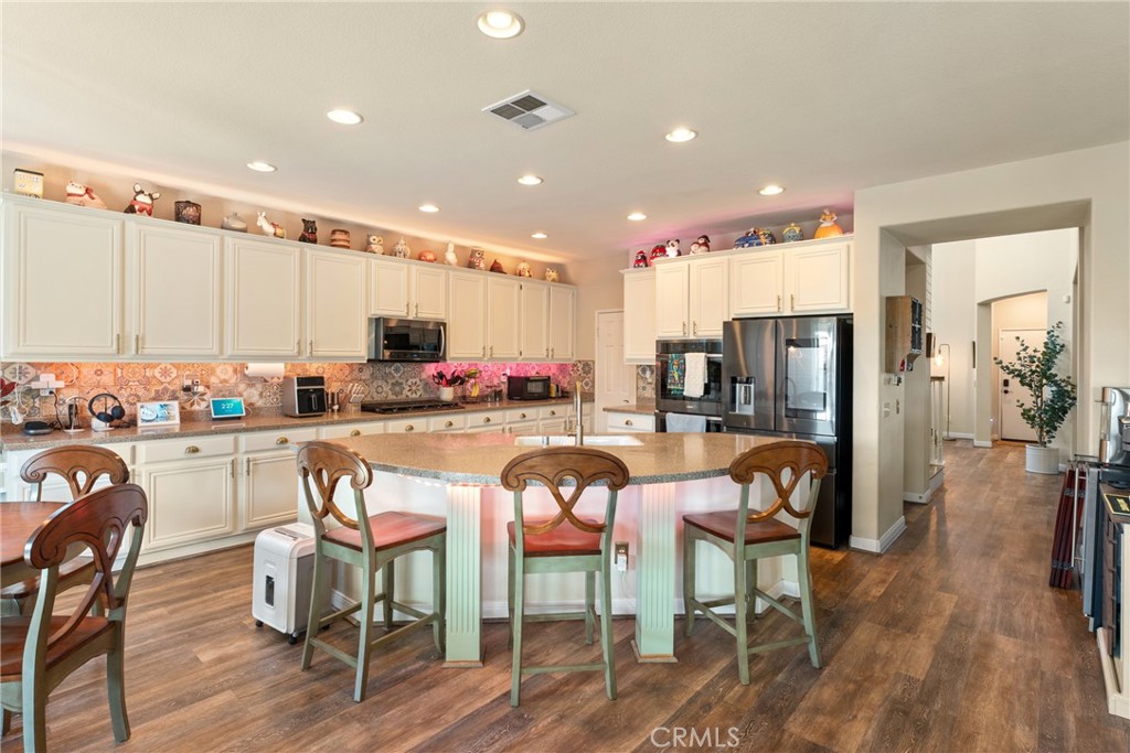 8553 Lodgepole Lane Riverside, CA 92508 - Photo 19 of 75 a view of a dining room with furniture window and wooden floor