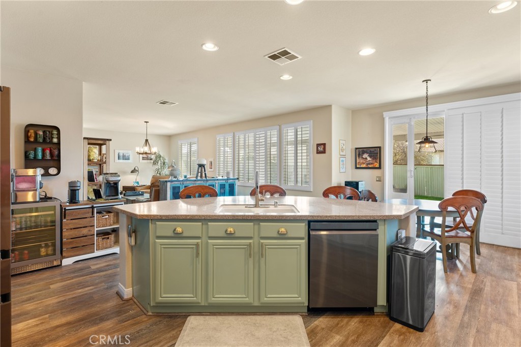 8553 Lodgepole Lane Riverside, CA 92508 - Photo 25 of 75 a dining hall with stainless steel appliances granite countertop a stove and a dining table with wooden floor