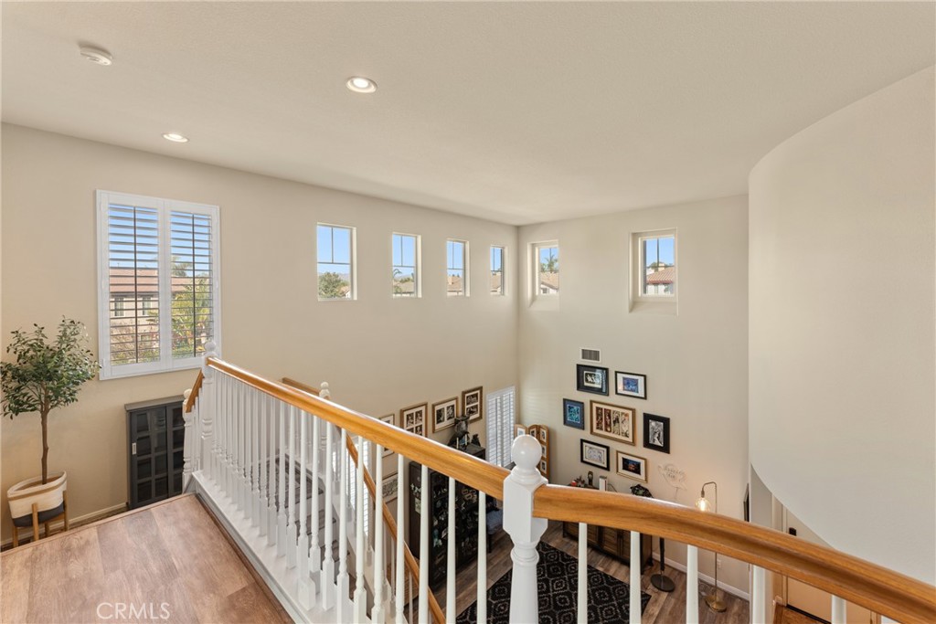 8553 Lodgepole Lane Riverside, CA 92508 - Photo 27 of 75 a view of a hallway with wooden floor and staircase