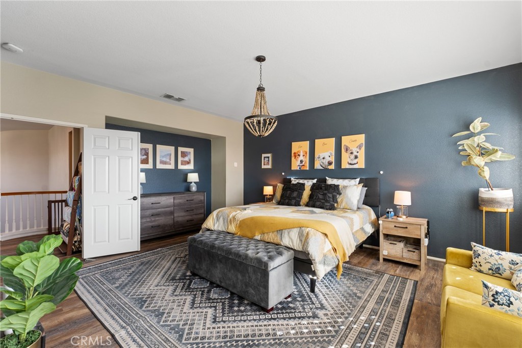 8553 Lodgepole Lane Riverside, CA 92508 - Photo 31 of 75 a bed room with a bed and a chandelier