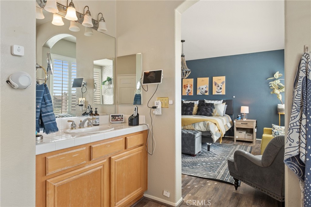 8553 Lodgepole Lane Riverside, CA 92508 - Photo 34 of 75 a living room with furniture a chandelier and a flat screen tv
