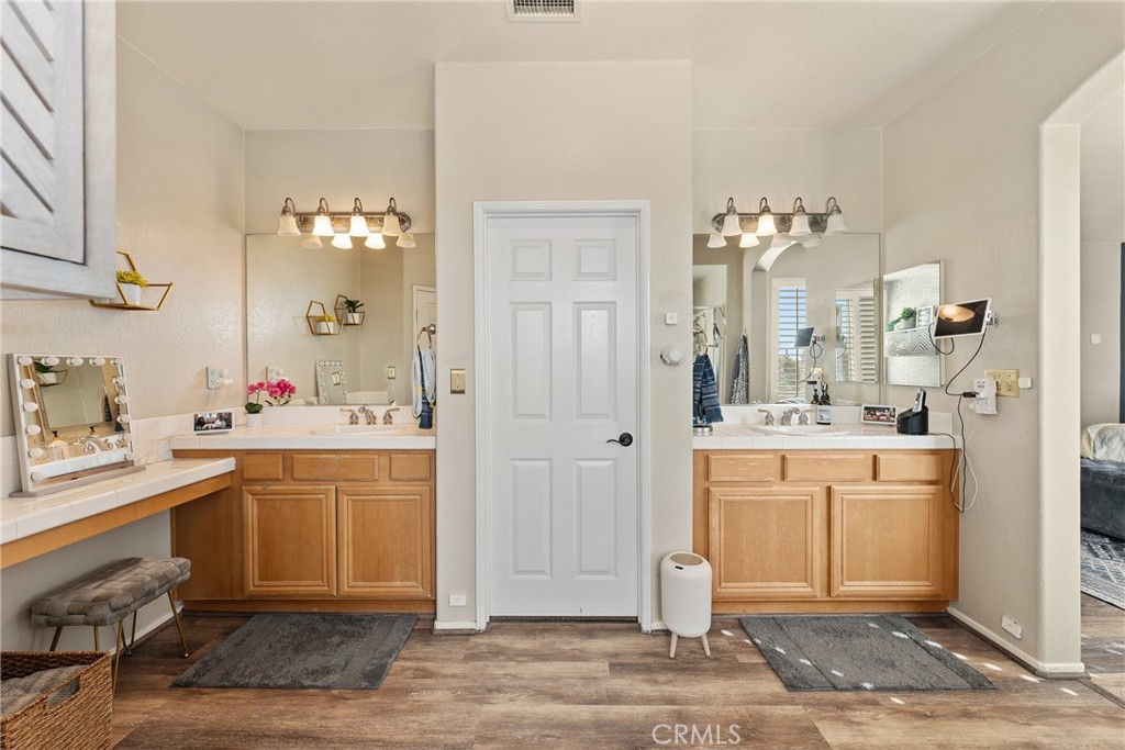 8553 Lodgepole Lane Riverside, CA 92508 - Photo 36 of 75 a spacious bathroom with a shower sink and mirror