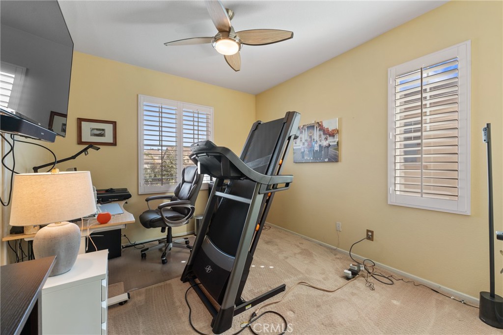 8553 Lodgepole Lane Riverside, CA 92508 - Photo 39 of 75 a view of a workspace with furniture and a window