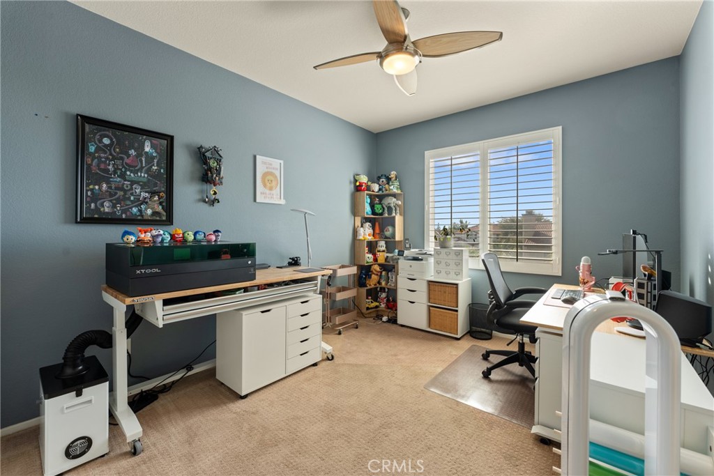 8553 Lodgepole Lane Riverside, CA 92508 - Photo 40 of 75 a view of a workspace with furniture and a window