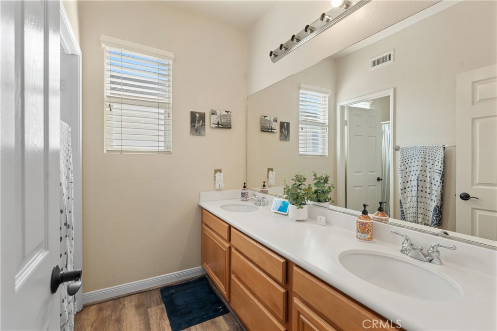 8553 Lodgepole Lane Riverside, CA 92508 - Photo 44 of 75 a bathroom with a sink a vanity and a mirror