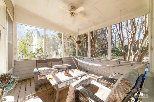 a living room with a large window and furniture