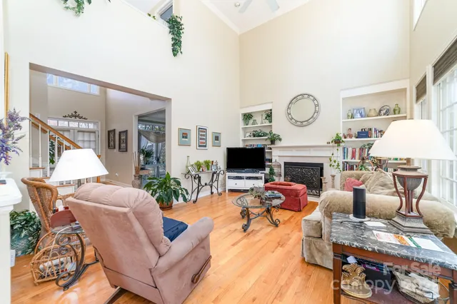 a living room with furniture a fireplace and a table
