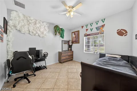 a bedroom with a bed and a chair