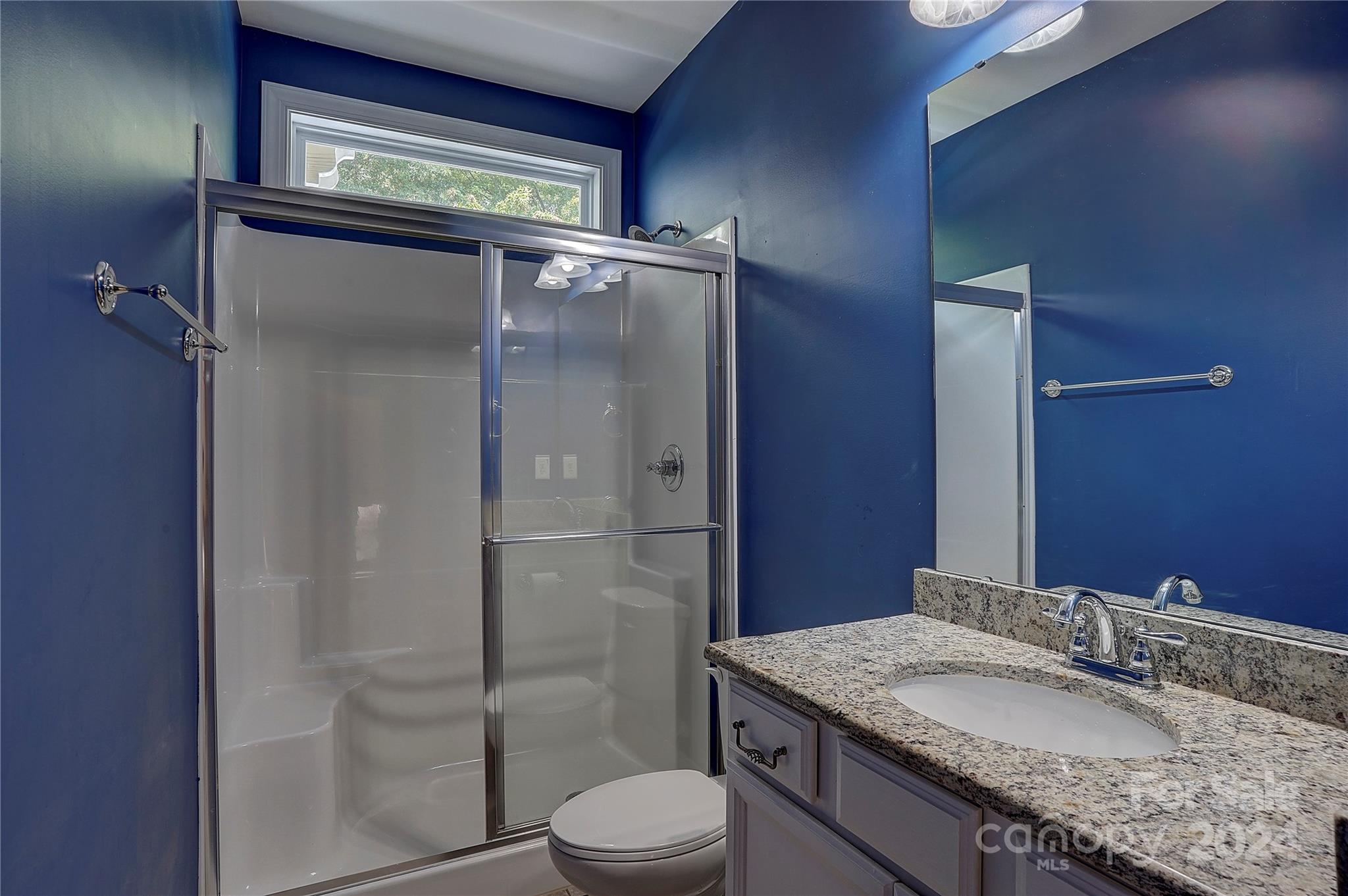 1024 Ridgehaven Road Waxhaw, NC 28173 - Photo 13 of 36 a bathroom with a granite countertop sink toilet and shower