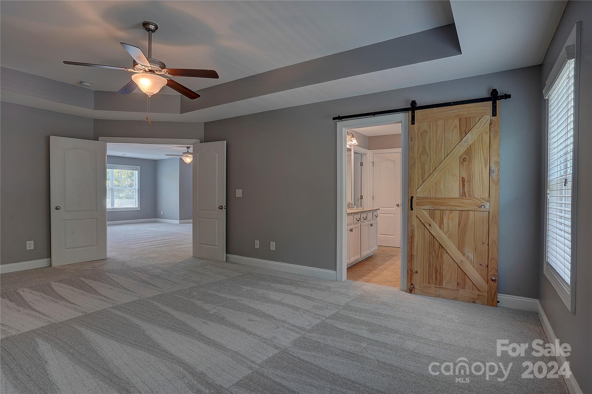 1024 Ridgehaven Road Waxhaw, NC 28173 - Photo 15 of 36 a view of an empty room with a ceiling fan window and a ceiling fan