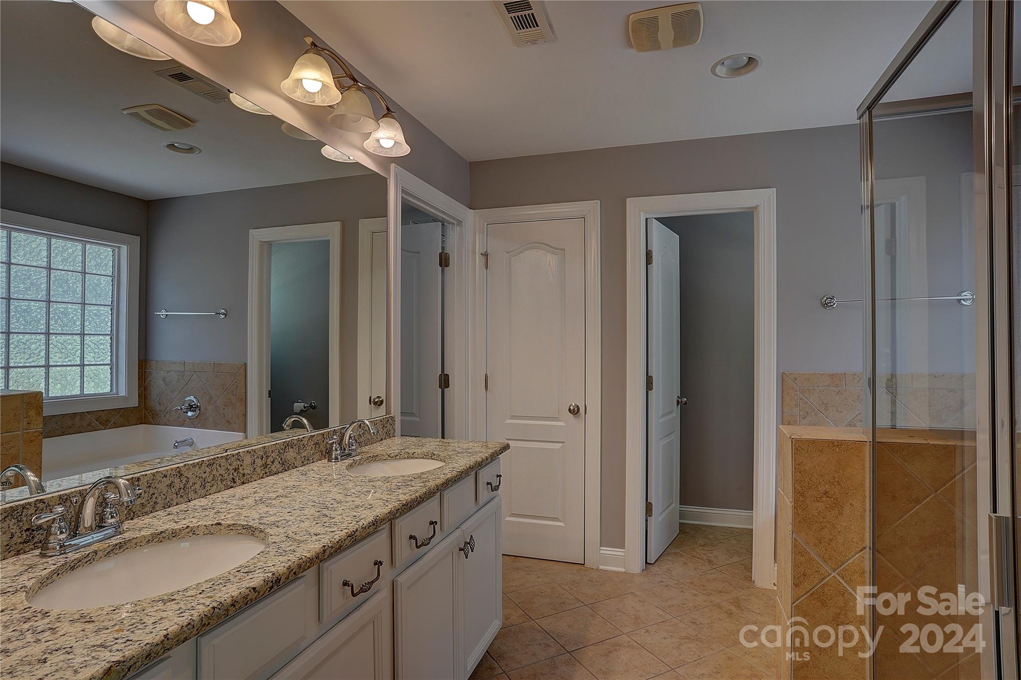 1024 Ridgehaven Road Waxhaw, NC 28173 - Photo 16 of 36 a bathroom with a granite countertop sink and a mirror