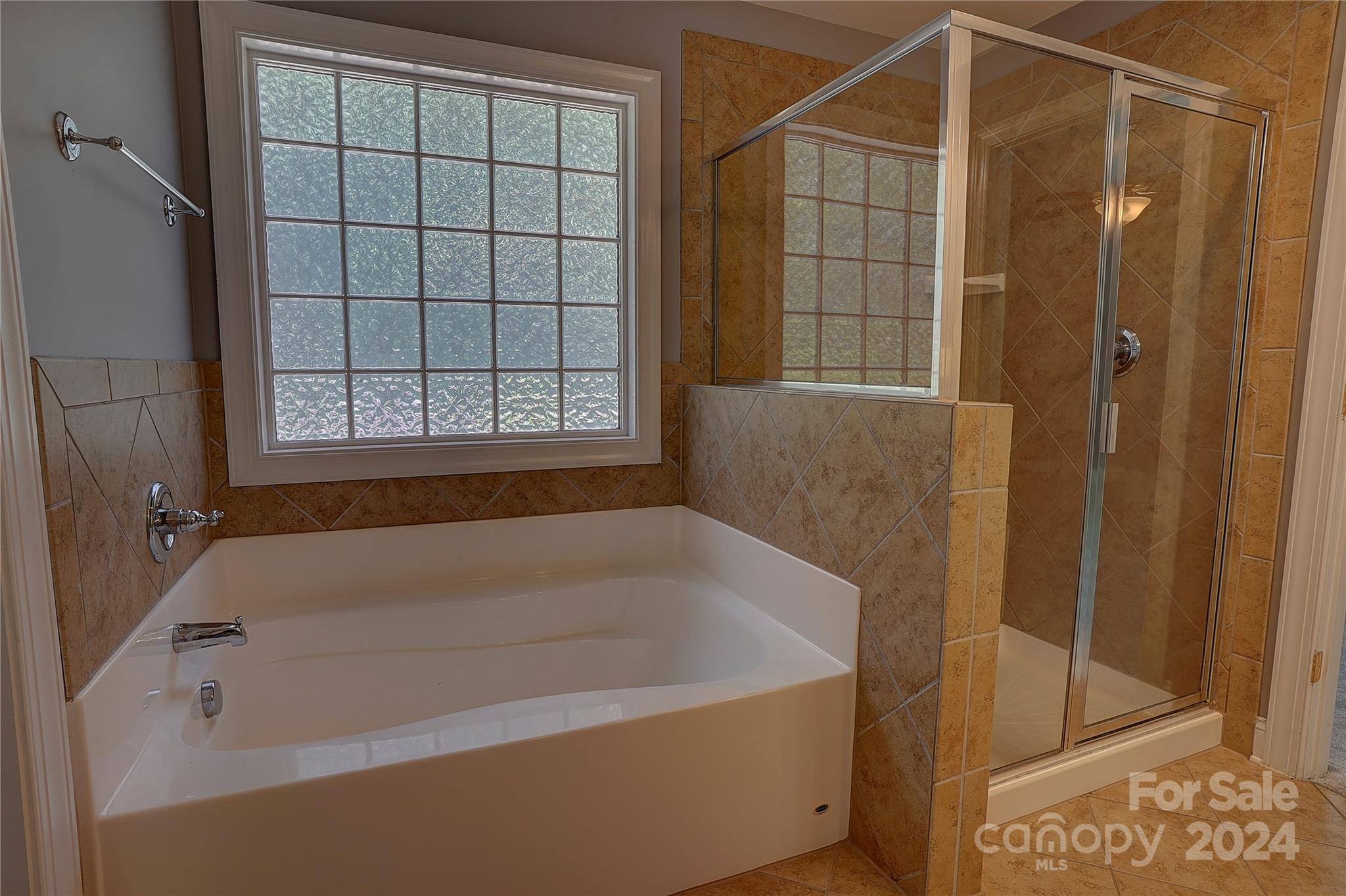 1024 Ridgehaven Road Waxhaw, NC 28173 - Photo 17 of 36 a bathroom with a bath tub and shower