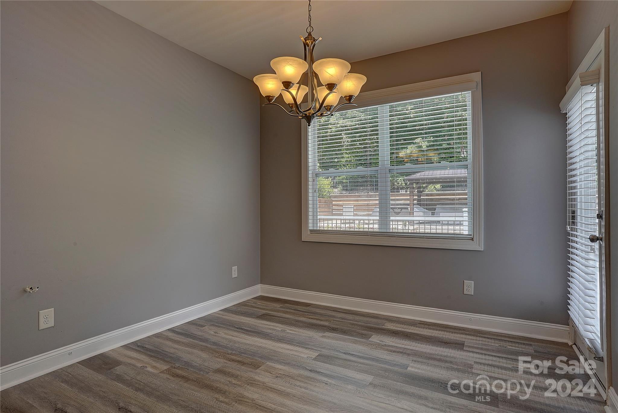 1024 Ridgehaven Road Waxhaw, NC 28173 - Photo 7 of 36 a view of wooden floor and chandelier in a room