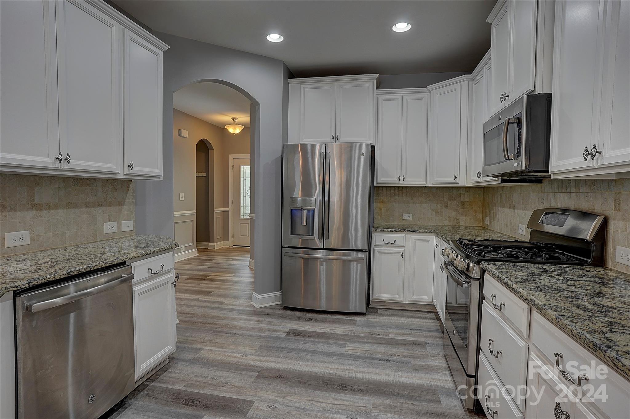 1024 Ridgehaven Road Waxhaw, NC 28173 - Photo 8 of 36 a kitchen with stainless steel appliances granite countertop a stove a refrigerator and a sink