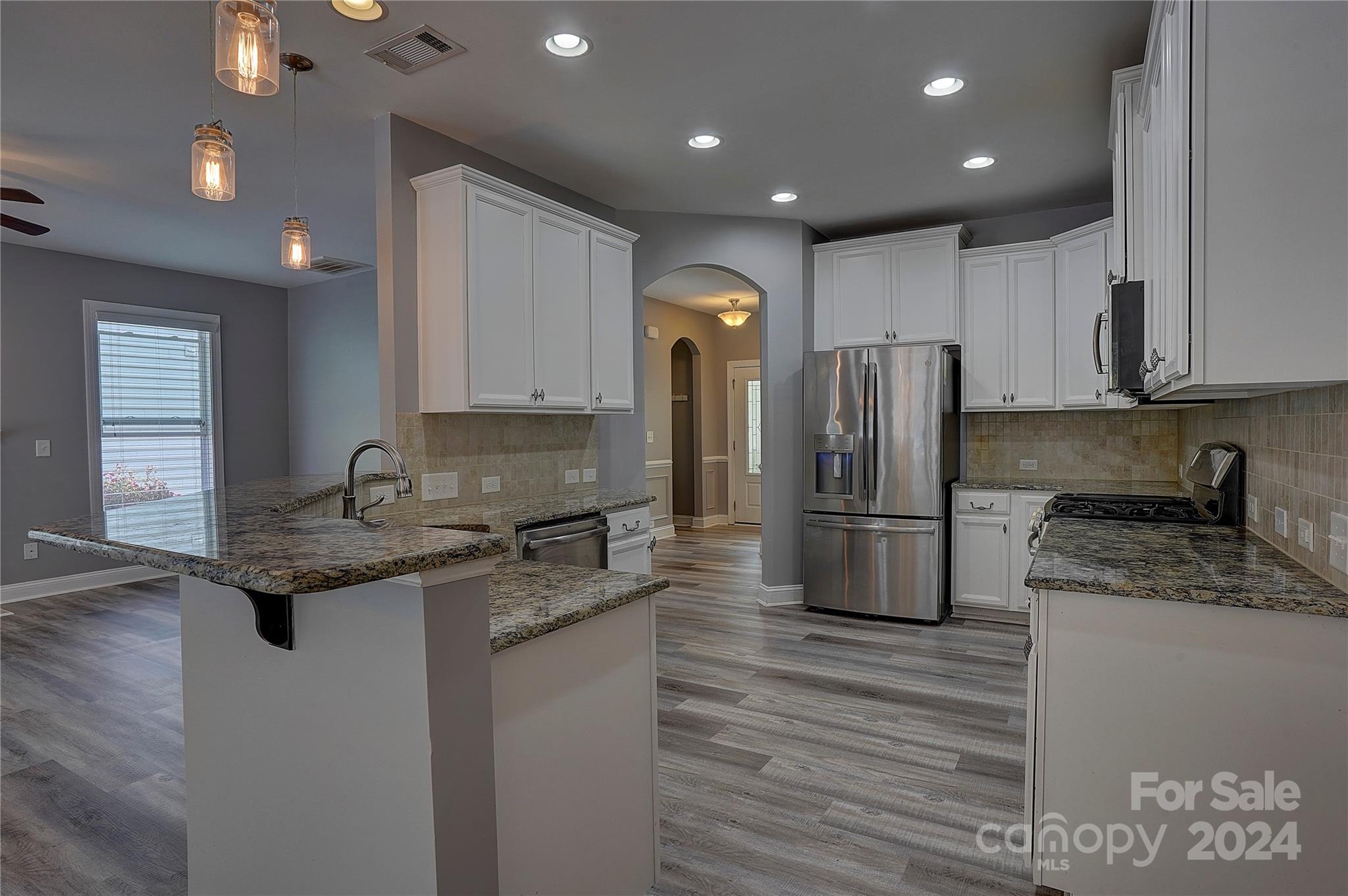 1024 Ridgehaven Road Waxhaw, NC 28173 - Photo 10 of 36 a kitchen with stainless steel appliances granite countertop a sink stove and refrigerator