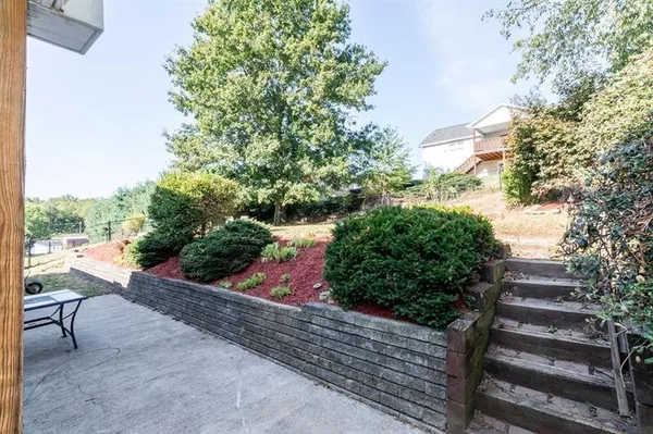 a view of a garden with wooden bench
