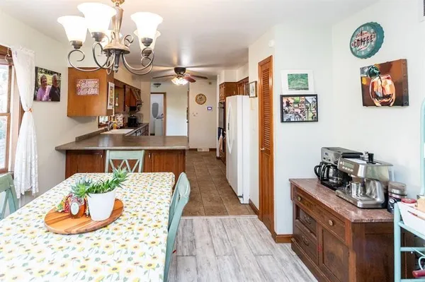a view of a dining room with furniture a chandelier and wooden floor