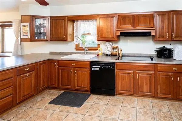 a kitchen with stainless steel appliances granite countertop a sink and cabinets