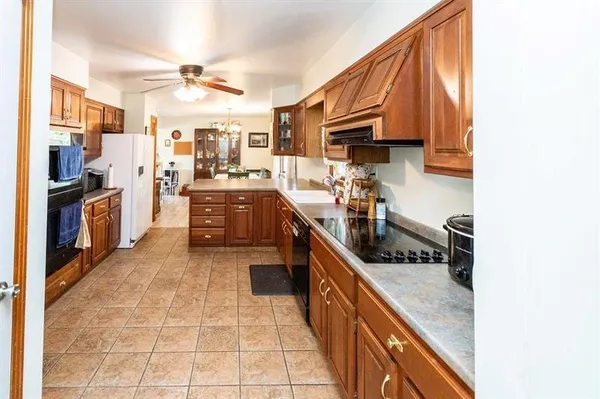a kitchen with stainless steel appliances granite countertop a stove and a refrigerator