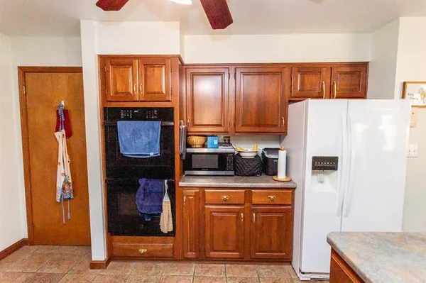 a kitchen with stainless steel appliances granite countertop a refrigerator and a stove