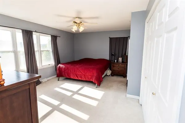 a bedroom with a bed and a flat tv screen