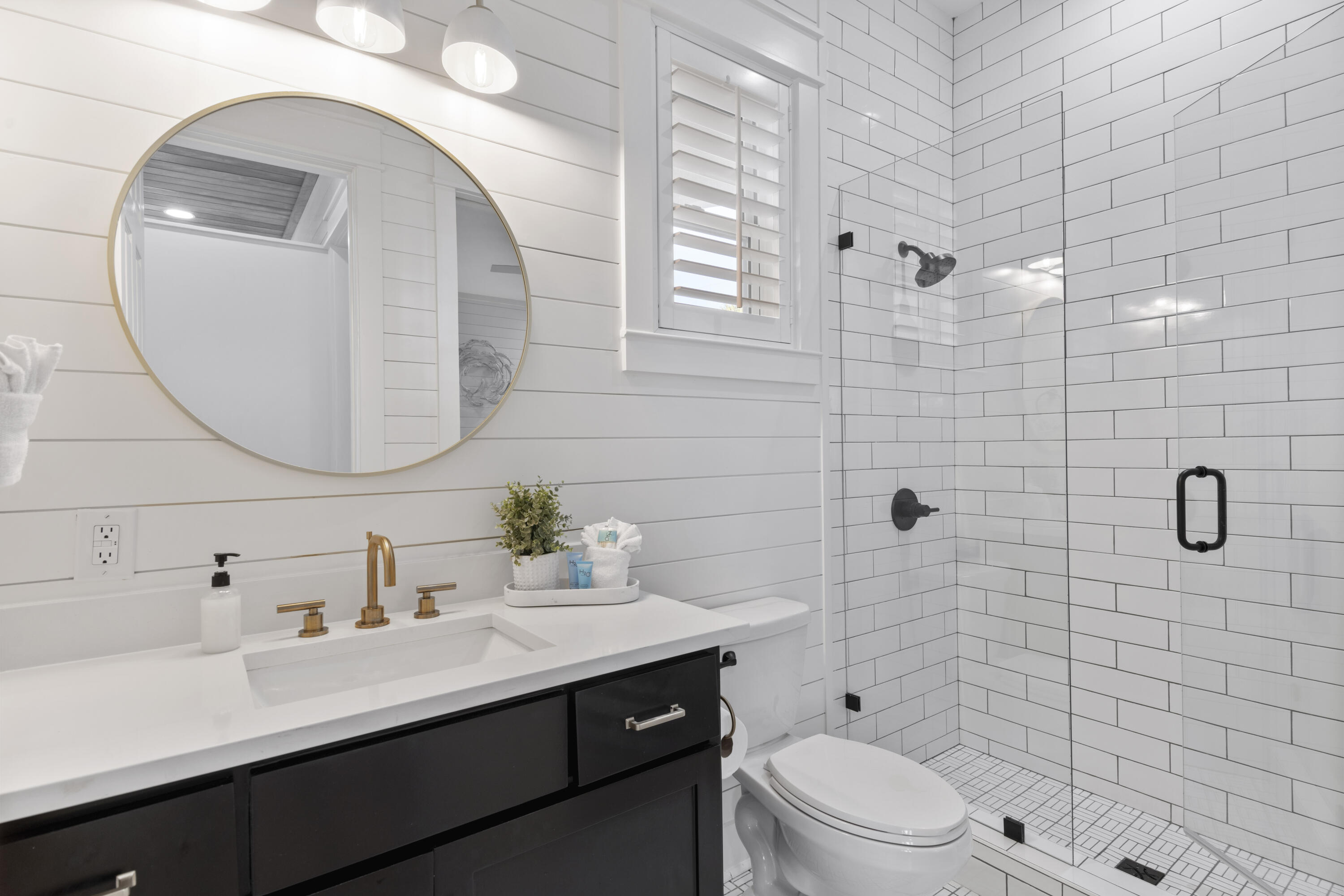 27 Old Mill Road Santa Rosa Beach, FL 32459 - Photo 25 of 43 a bathroom with a sink a toilet a mirror and shower