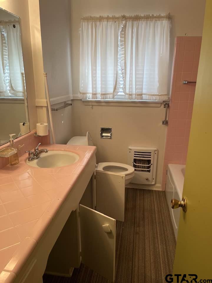 2806 North Glass Avenue Tyler, TX 75702 - Photo 12 of 25 a bathroom with a sink and a toilet