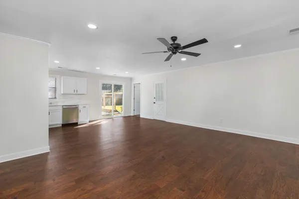 a view of empty room with wooden floor and window