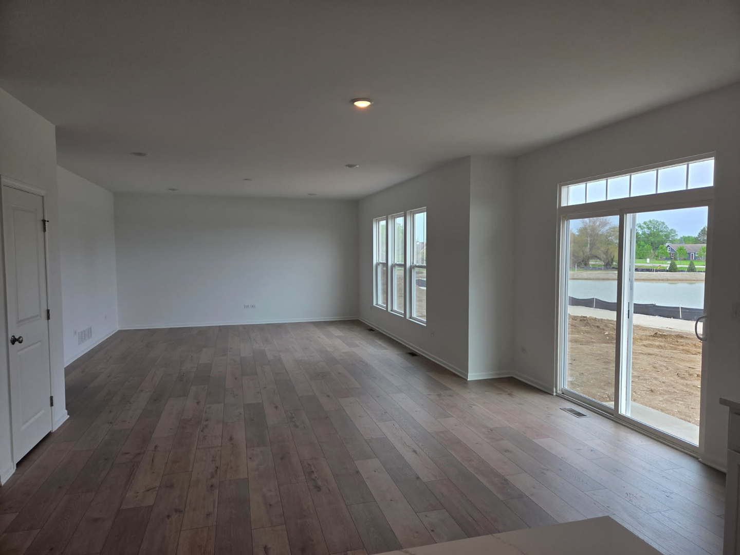 17431 Victoria Lane Lockport, IL 60441 - Photo 6 of 20 a view of an empty room with a window and wooden floor