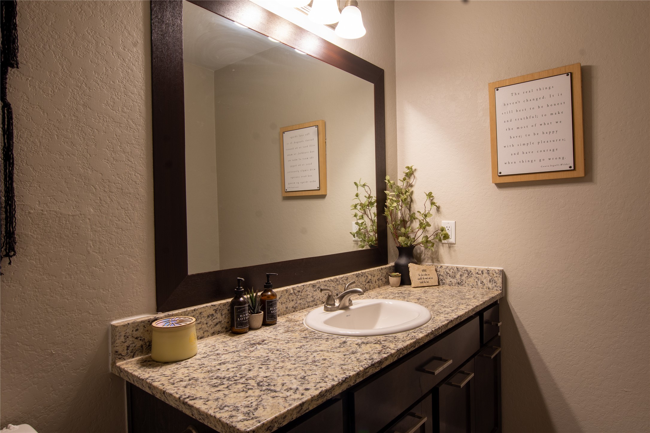 38340 Park View Drive Hempstead, TX 77445 - Photo 16 of 25 a bathroom with a granite countertop sink and a mirror