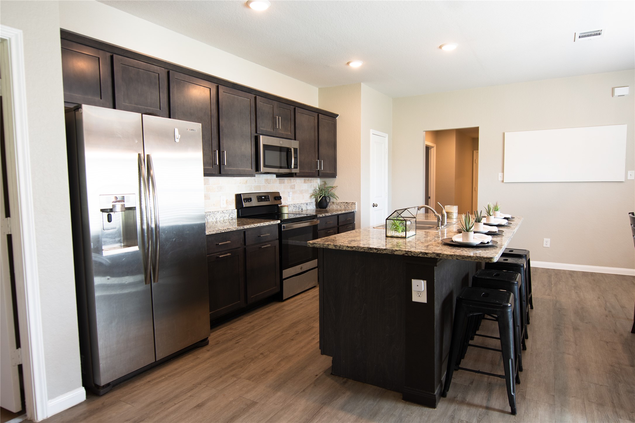 38340 Park View Drive Hempstead, TX 77445 - Photo 7 of 25 a kitchen with stainless steel appliances a refrigerator a sink a stove a dining table and chairs