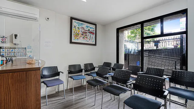 a view of a workspace with furniture and a window