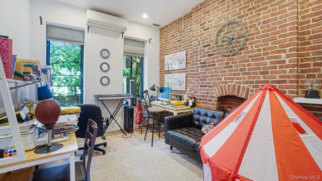a view of a livingroom with workspace and a window