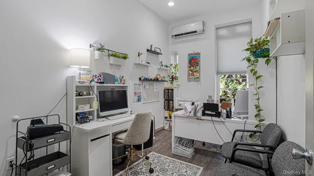 a view of a kitchen with furniture and refrigerator