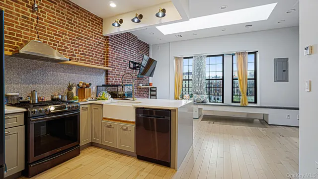 a kitchen with stainless steel appliances granite countertop a stove and a refrigerator